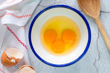 Three egg yolks in a bowl - top view