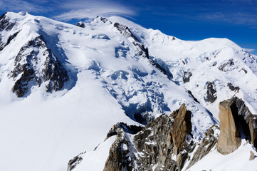 Mont Blanc, glacier and Rock Climber from Aiguille du Midi in chamonix France.