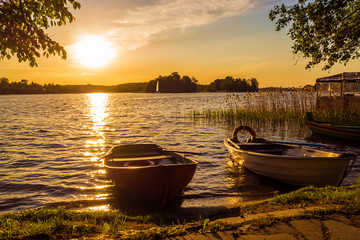 Boats at sunset by Trakai Island Castle - a popular tourist destination in Lithuania