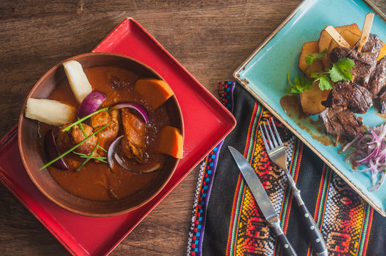 Sancochado traditional south american peruvian chilean soup and anticuchas de corason