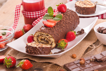 Chocolate roll with strawberries. 