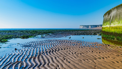 Panoramic view of sea at low tide and beach in Kingsgate Bay, Margate, East Kent, UK