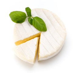 Piece of camembert cheese isolated on white background. From top view.