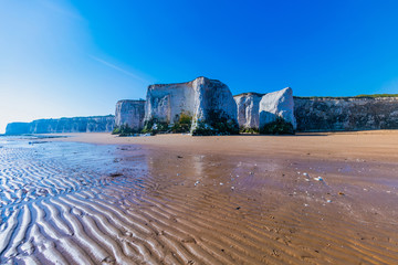 View of white chalk stacks, cliffs, sea at low tide and beach in Botany Bay, Margate, East Kent, UK