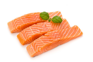 Fresh salmon fillet with basil on the white background.