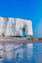 View of white chalk stacks and cliffs, sea at low tide and beach in Kingsgate Bay, Margate, East...