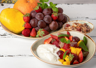 Fruit berry salad with yogurt and granola for healthy breakfast