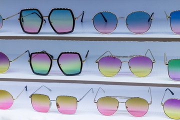 Sunglass shop selling different bright colored funky glasses for UV protection from the sun.  Eye glass online store.