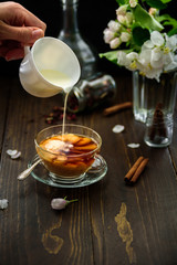 A glass of black tea with milk