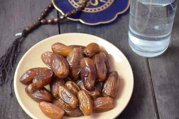 A glass of drinking water and date fruits - a food that is consumed before breaking fast during holy month of Ramadan.