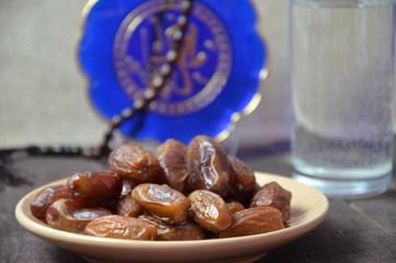 A glass of drinking water and date fruits - a food that is consumed before breaking fast during holy month of Ramadan.