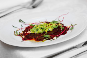 vegan gluten-free avocado salsa, beetroot carpaccio, emulsion from xylitol and pine with cashew nuts