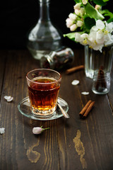 A glass of black tea with cinnamon