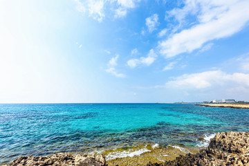 Fototapeta na wymiar Daylight view to Nissi Beach with colorful bright blue water and sky