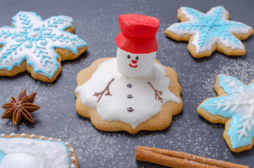 homemade christmas cookies, melted snowman with red hut and snowflake gingerbread