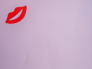 Red female lips  on pink background with copy space