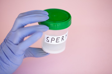 Health. Sperm Analysis. Concept of Bank Sperm. Infertility. Doctor's Hand Holding Container for Analyzes.