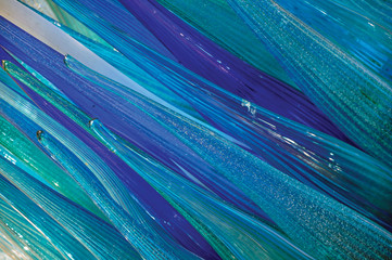Close-up of the blue and green tones of a star shape sculpture made of glass in Murano, a small and...
