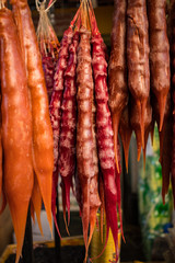 Churchkhela. Traditional Georgian homemade sweets with hazelnuts, walnuts, grape juice, honey (sugar), wheat flour (corn flour). Dessert sold in local food market in Georgia, Tbilisi or Batumi.