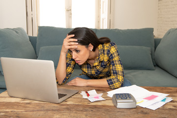 Worried attractive woman managing expenses with laptop. living cost and paying bills problem