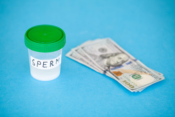 Health. Close up Concept of Bank Sperm. Infertility Bank with Sperm. Doctor's Hand Holds Container for Analyzes. Sperm Analysis on Blue Background.