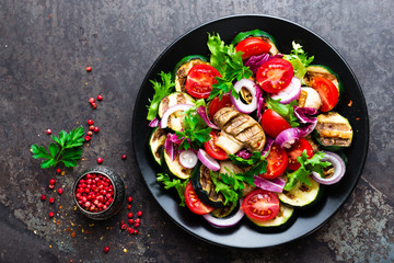 Salad with fresh and grilled vegetables and mushrooms. Vegetable salad with grilled champignons. Vegetable salad on plate. Healthy vegetarian food