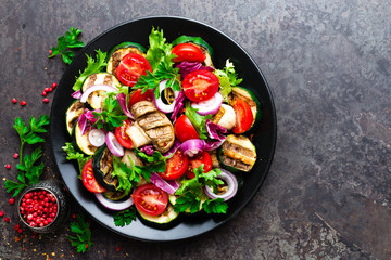 Salad with fresh and grilled vegetables and mushrooms. Vegetable salad with grilled champignons. Vegetable salad on plate. Healthy vegetarian food