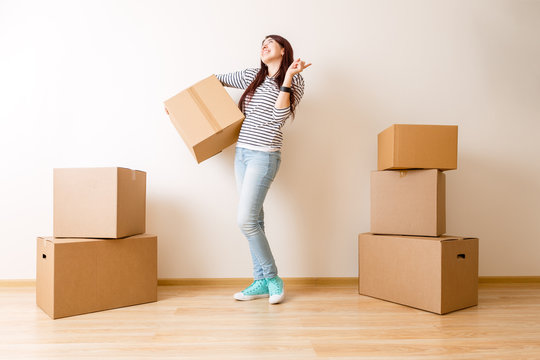 Image of young woman among cardboard boxes