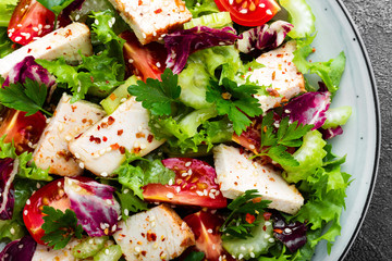 Meat salad with fresh vegetables. Vegetable salad with baked chicken breast. Vegetable salad with chicken fillet on plate
