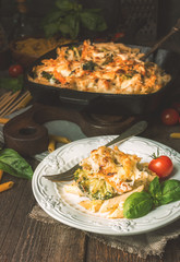 Baked pasta with broccoli, cauliflower, cheese and bechamel sauc
