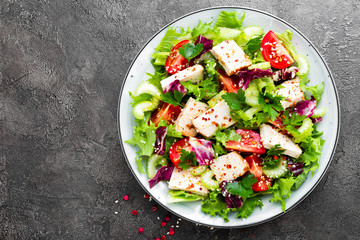 Meat salad with fresh vegetables. Vegetable salad with baked chicken breast. Vegetable salad with chicken fillet on plate