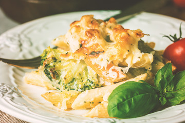 Baked pasta with broccoli, cauliflower, cheese and bechamel sauc