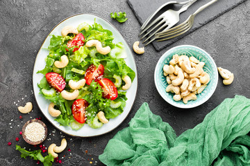 Salad with fresh vegetables and nuts. Vegetable salad with fresh vegetables and cashew. Vegetable salad on plate. Healthy vegetarian food