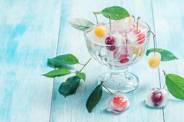 Cherry in ice cube in glass bowl 