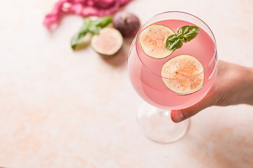 Pink cocktail with fig