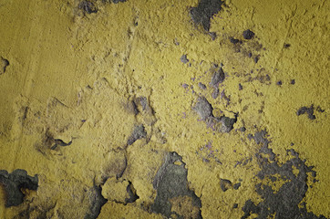 Yellow grunge wall with paint peeling off