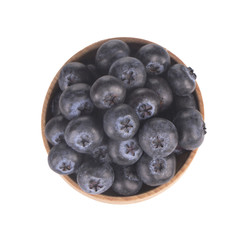 heap of blueberries in wooden cup isolated on white background. top view