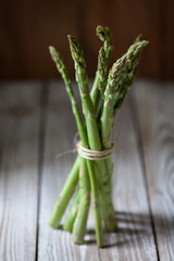 fresh green asparagus on wooden background