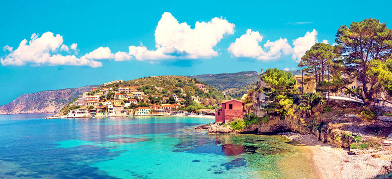 Fototapeta Beautiful landscape with bay and colorful buildings on the background of picturesque clouds in the town of Asos, Greece, Kefalonia. Wonderful exciting places. Panorama.