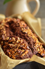 Chocolate cake with strawberries sprinkled with crushed nuts
