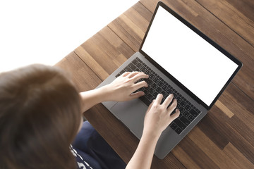 Women using laptop with blank screen at table in the office