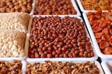 Nuts and dried fruits, on the market counter.