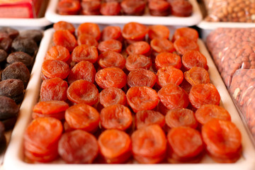 Dried apricots, dried fruits, on the market counter.