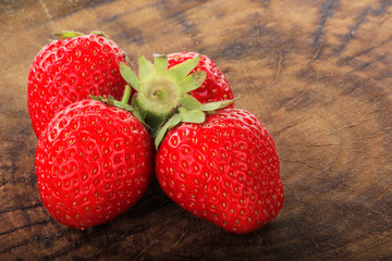 heap of strawberry on woodedn background