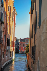 Panoramic view of buildings on a canal that ends on another canal at the sunset, in the city center of Venice, the historic and amazing marine city. Located in the Veneto region, northern Italy
