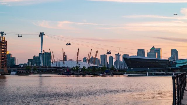 8k timelapse of cable cars in the dockland district in London at sunset, transition to night