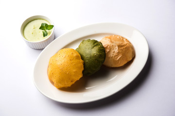 fried Plain Puri , spinach and masala poori served with green chutney, selective focus