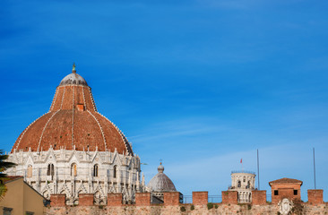 Obraz premium Pisa famous landmarks: Leaning Tower, Baptistry and Cathedral, seen from outiside the city ancient walls (with copy space above)
