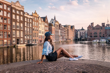 woman waterfront amsterdam sunset - obrazy, fototapety, plakaty