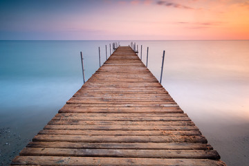 Fototapeta na wymiar sunset pier in the sea of minimalism